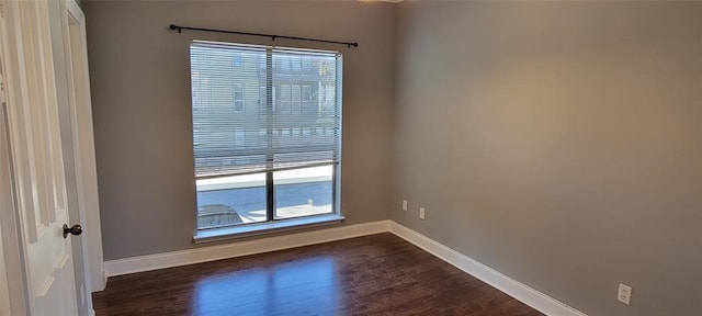 unfurnished room with dark hardwood / wood-style flooring