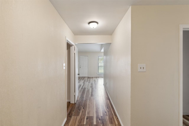 hallway with dark hardwood / wood-style floors