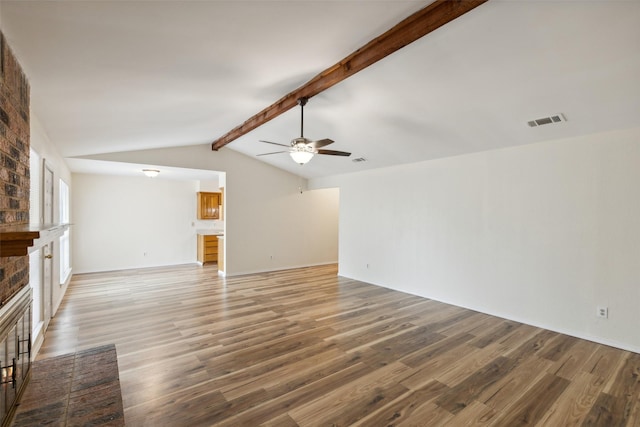 unfurnished living room with vaulted ceiling with beams, ceiling fan, a fireplace, and wood-type flooring