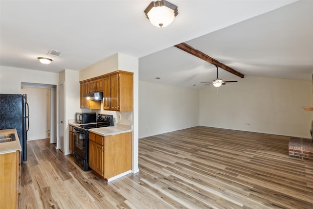 kitchen with vaulted ceiling with beams, ceiling fan, light hardwood / wood-style flooring, and black appliances