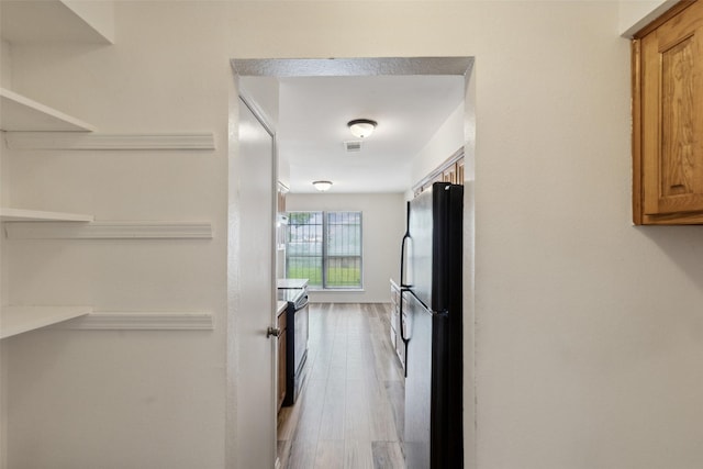 hall with hardwood / wood-style flooring