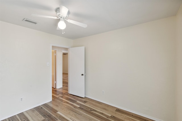 spare room featuring ceiling fan and light wood-type flooring