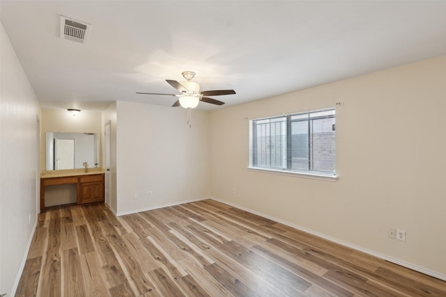 empty room with light hardwood / wood-style floors and ceiling fan