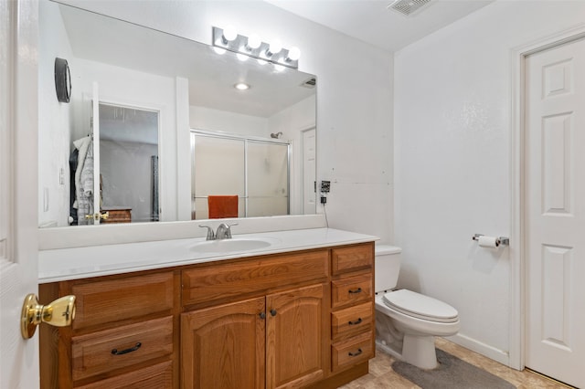 bathroom with tile patterned flooring, vanity, toilet, and walk in shower