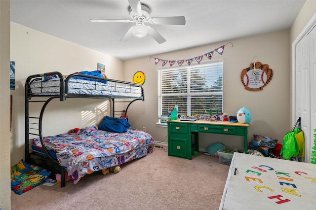 carpeted bedroom featuring ceiling fan and a closet