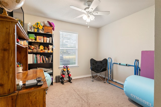 exercise room featuring light carpet and ceiling fan