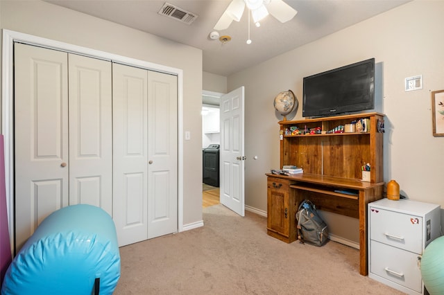 office area with washer / clothes dryer, ceiling fan, and light colored carpet