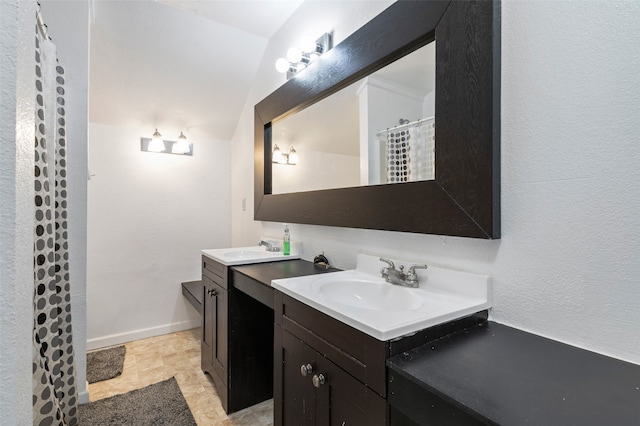 bathroom featuring vanity and vaulted ceiling