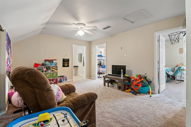 game room featuring carpet flooring, a textured ceiling, vaulted ceiling, and ceiling fan