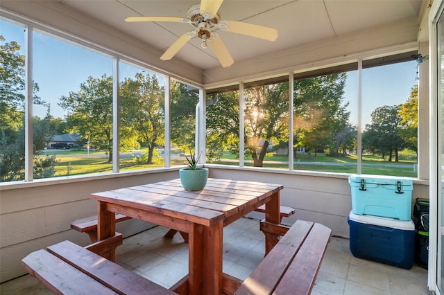 unfurnished sunroom with ceiling fan and plenty of natural light