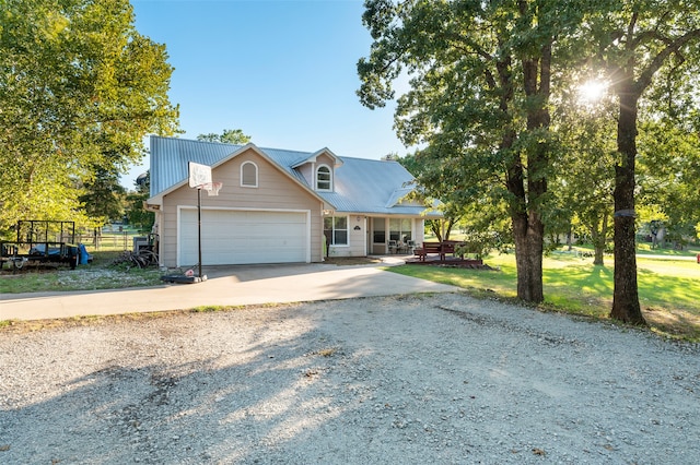 view of front of home with a front yard and a garage