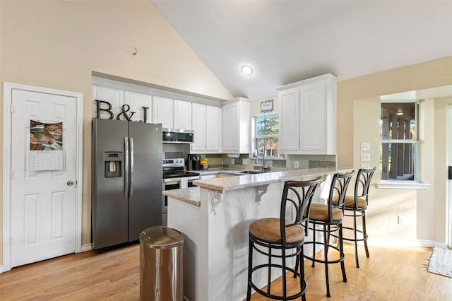 kitchen featuring light stone counters, stainless steel appliances, sink, light hardwood / wood-style floors, and white cabinetry