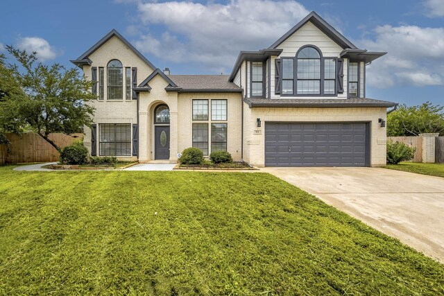 view of front of house with a garage and a front yard