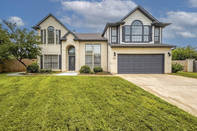 view of front of house with brick siding, an attached garage, fence, driveway, and a front lawn