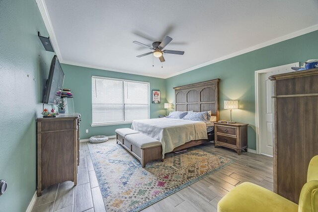 bedroom with ceiling fan, light hardwood / wood-style floors, and ornamental molding