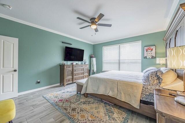 bedroom with ceiling fan, hardwood / wood-style flooring, and ornamental molding