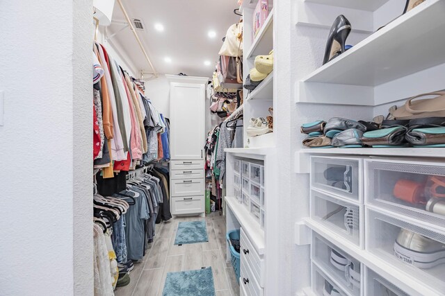 walk in closet featuring light hardwood / wood-style flooring