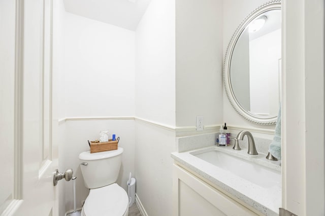 bathroom with toilet and vanity