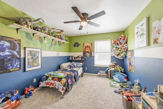 carpeted bedroom featuring ceiling fan and a textured ceiling