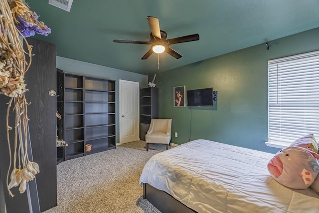 bedroom with visible vents, ceiling fan, carpet flooring, and multiple windows