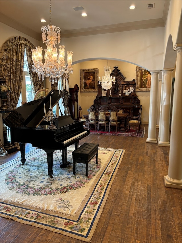 misc room with decorative columns, dark wood-type flooring, and ornamental molding