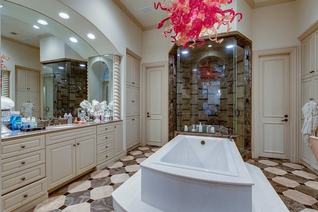 bathroom featuring vanity, ornamental molding, and shower with separate bathtub