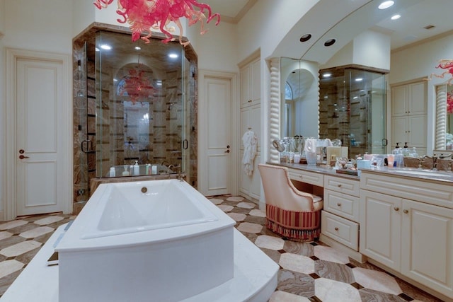 bathroom with plus walk in shower, vanity, and crown molding