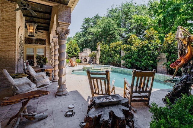 view of swimming pool with an in ground hot tub, a patio, and ceiling fan