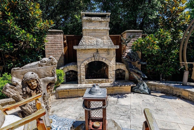 view of patio / terrace featuring an outdoor stone fireplace