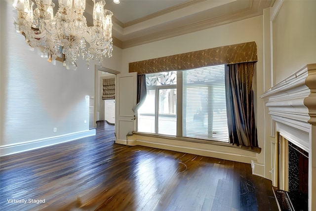 unfurnished living room with ornamental molding, dark wood-type flooring, and a notable chandelier