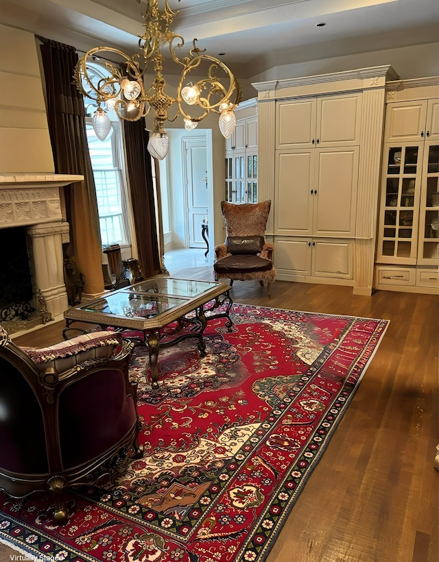 sitting room featuring a chandelier, dark wood-type flooring, and a high end fireplace