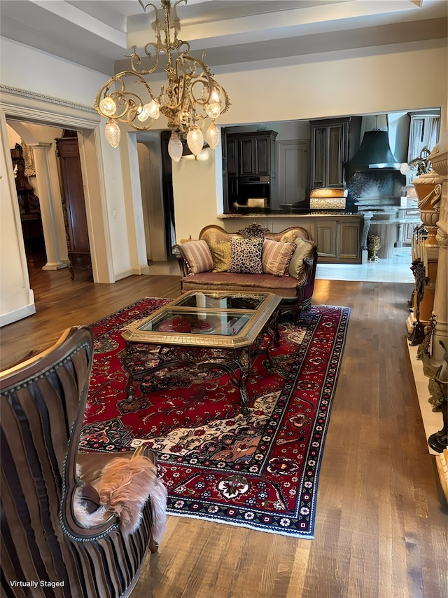 living room featuring dark hardwood / wood-style floors and an inviting chandelier