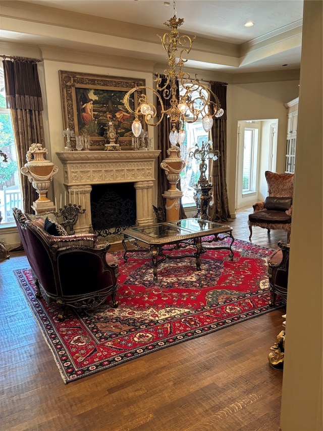 living room featuring wood-type flooring and a tray ceiling