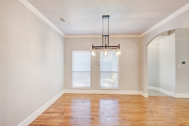 unfurnished dining area featuring light hardwood / wood-style flooring and ornamental molding