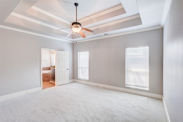 unfurnished room featuring crown molding, ceiling fan, carpet floors, and a tray ceiling