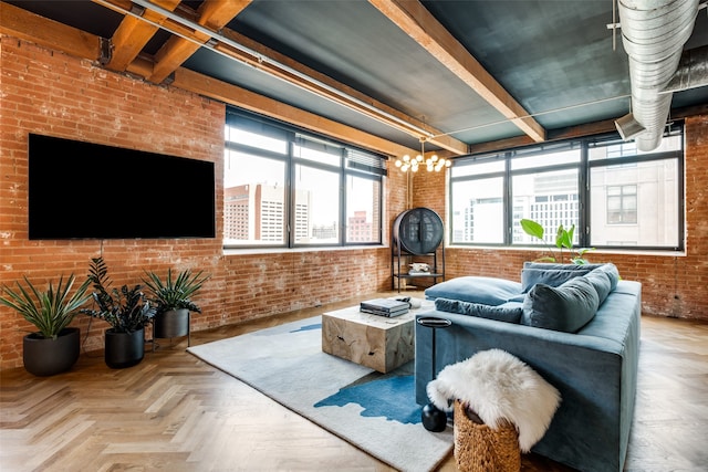 living room with brick wall, an inviting chandelier, and light parquet floors