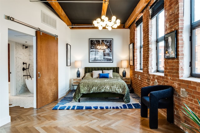 bedroom with a notable chandelier, brick wall, parquet floors, and a barn door