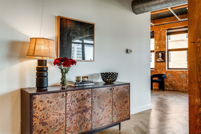 interior space featuring brick wall and parquet floors