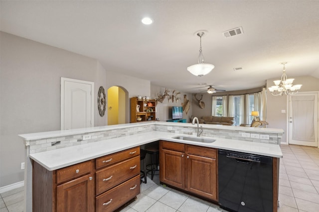 1600 Stanford Ln, Celina, TX 75009 - kitchen featuring black dishwasher, a sink, light countertops, arched walkways, and open floor plan