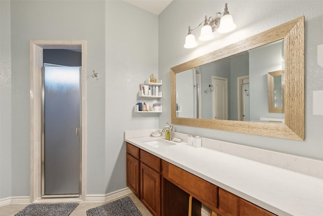 1600 Stanford Ln, Celina, TX 75009 - bathroom featuring vanity, a stall shower, baseboards, and tile patterned floors