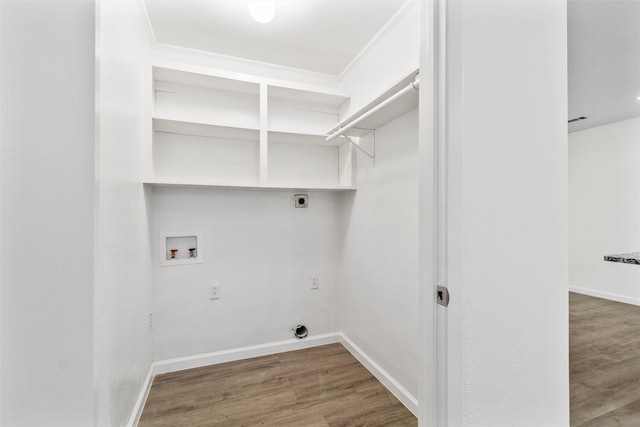 laundry room with hookup for a washing machine, crown molding, hardwood / wood-style flooring, and hookup for an electric dryer