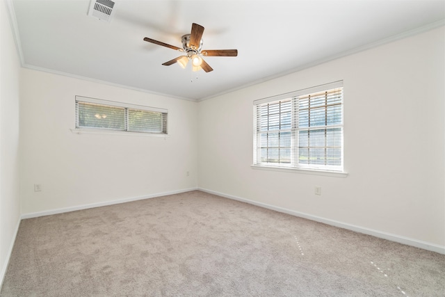 carpeted spare room featuring ceiling fan and ornamental molding