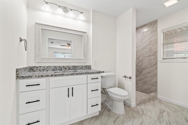 bathroom with vanity, toilet, ceiling fan, and walk in shower