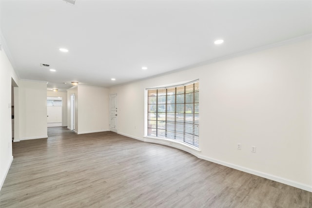 interior space with crown molding and light wood-type flooring