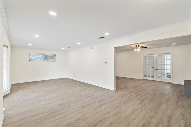 empty room with french doors, ceiling fan, crown molding, and light hardwood / wood-style floors