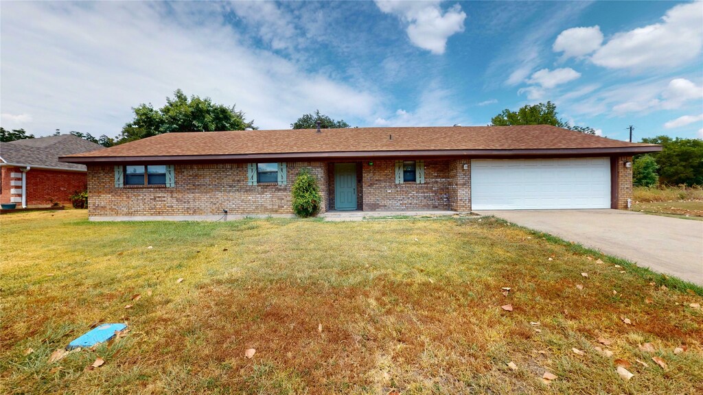 503 W Denison Cir, Bells, TX 75414 - ranch-style house with a garage, a front lawn, and brick siding