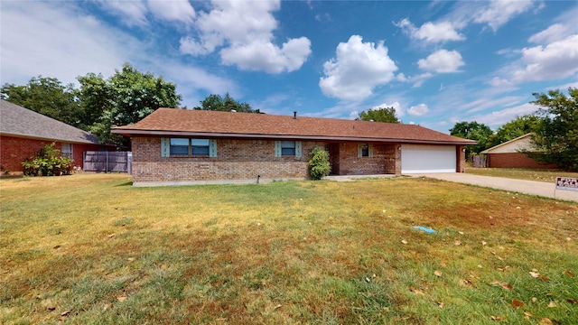 single story home featuring a garage and a front lawn