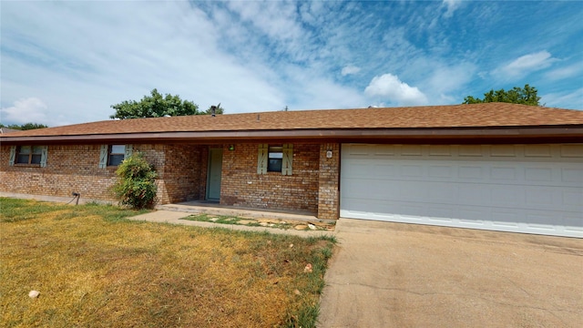 ranch-style home featuring a garage and a front yard