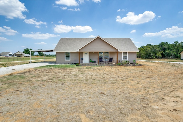 view of front of home with a carport and covered porch