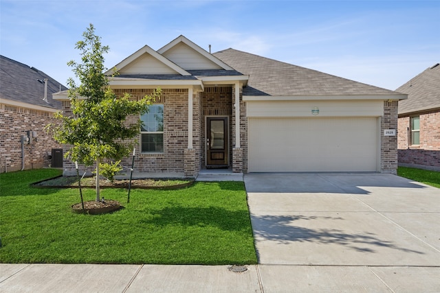 view of front of property with central air condition unit, a garage, and a front yard